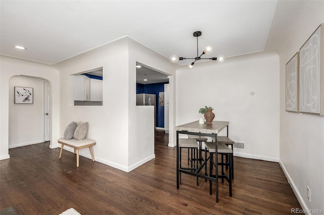 6390 W 45th Ave, Wheat Ridge, CO 80033 - dining area featuring dark wood-type flooring, arched walkways, and a chandelier