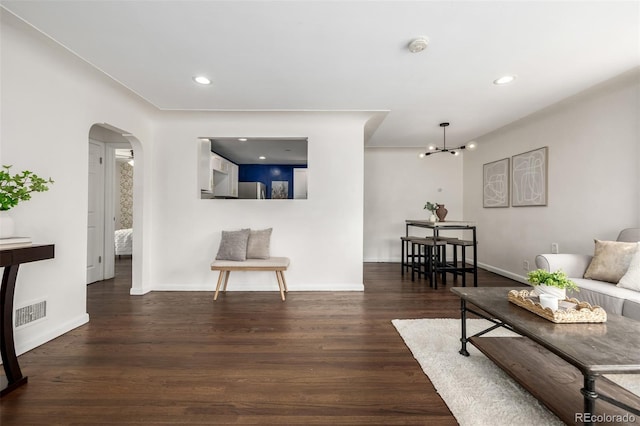 6390 W 45th Ave, Wheat Ridge, CO 80033 - living area featuring arched walkways, wood finished floors, and recessed lighting