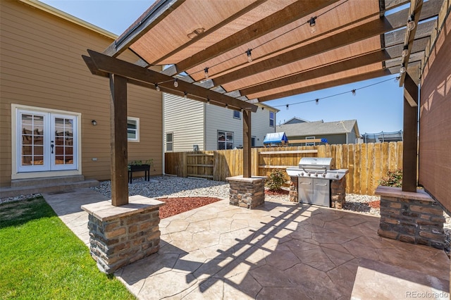 view of patio / terrace with a pergola, fence, area for grilling, and french doors