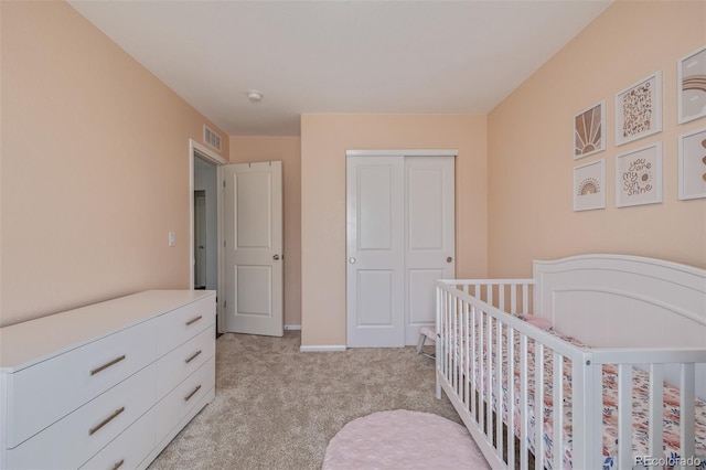 bedroom featuring light carpet, a closet, and visible vents