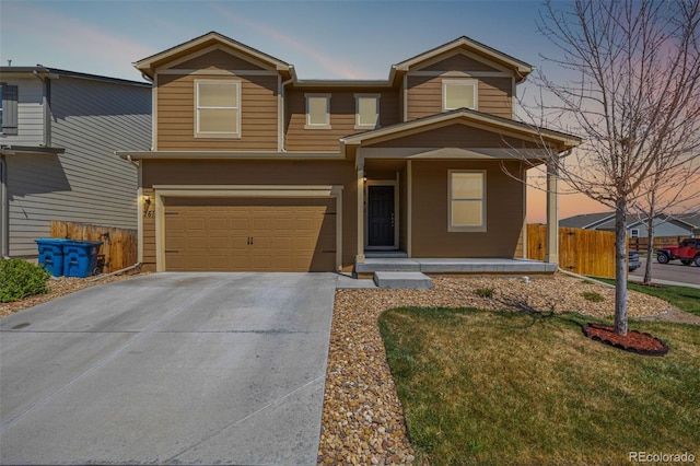 traditional-style house with an attached garage, concrete driveway, a porch, and fence