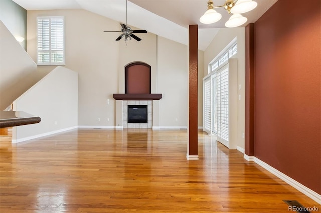 unfurnished living room featuring a fireplace, hardwood / wood-style floors, ceiling fan, and lofted ceiling