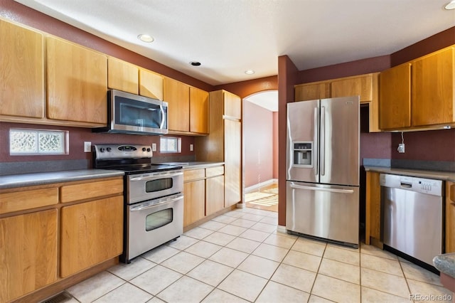 kitchen featuring light tile patterned floors and stainless steel appliances