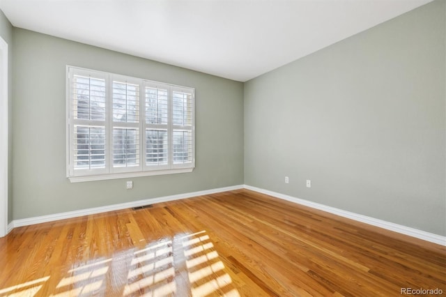 empty room with hardwood / wood-style flooring