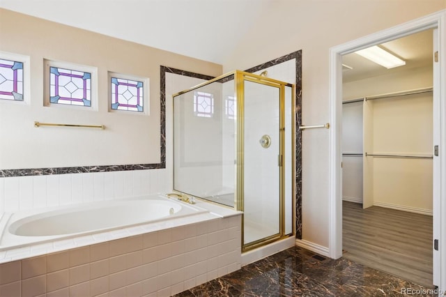 bathroom featuring independent shower and bath