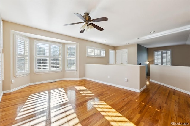 empty room featuring hardwood / wood-style floors and ceiling fan