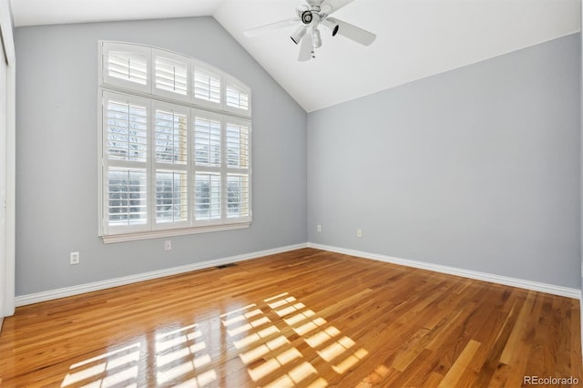 empty room featuring hardwood / wood-style floors, ceiling fan, and lofted ceiling