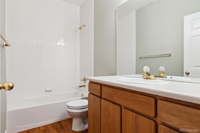 full bathroom featuring vanity, bathing tub / shower combination, hardwood / wood-style flooring, and toilet