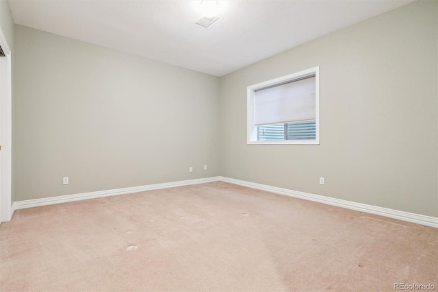 empty room featuring light colored carpet