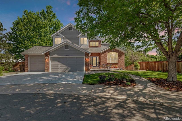 10345 Lions Heart, Lone Tree, CO 80124 - traditional home with brick siding, an attached garage, and driveway