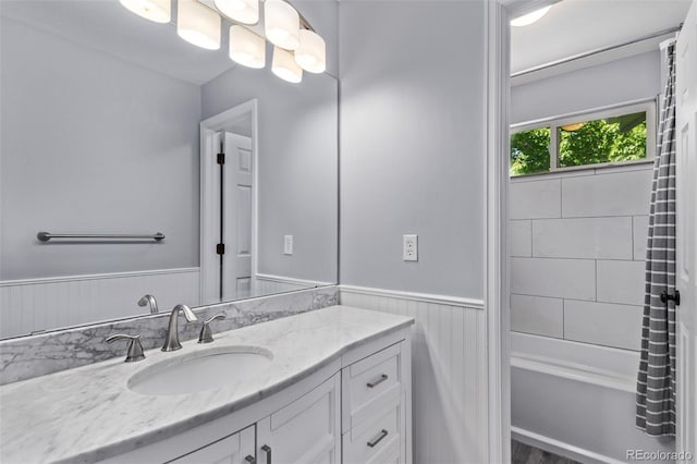 10345 Lions Heart, Lone Tree, CO 80124 - full bathroom with vanity, wainscoting, and shower / tub combo with curtain