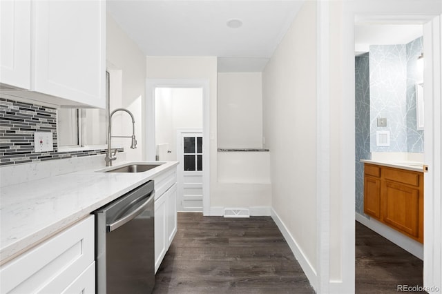 kitchen featuring white cabinetry, dishwasher, dark wood-type flooring, and light stone counters