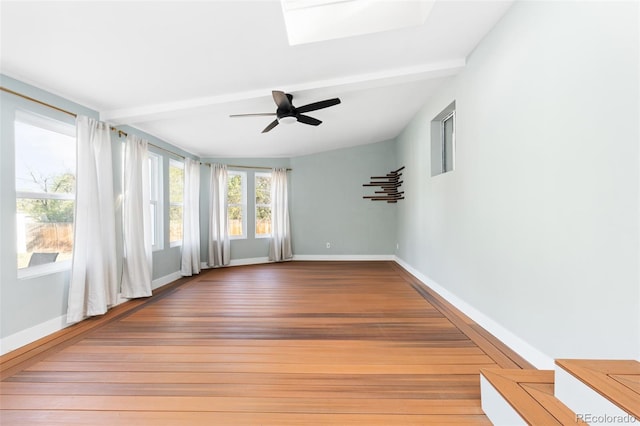 unfurnished sunroom featuring ceiling fan and lofted ceiling with skylight