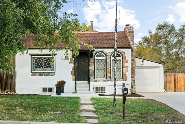 view of front facade with a garage and a front lawn