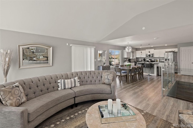 2970 Leoti Dr, Colorado Springs, CO 80922 - living area with vaulted ceiling, wood finished floors, and a chandelier