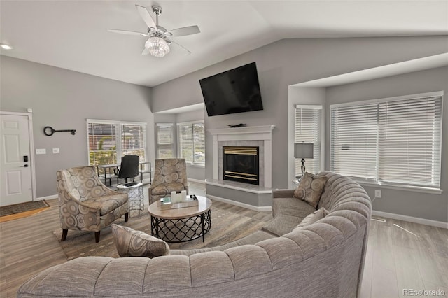 2970 Leoti Dr, Colorado Springs, CO 80922 - living area featuring vaulted ceiling, wood finished floors, baseboards, a ceiling fan, and a fireplace