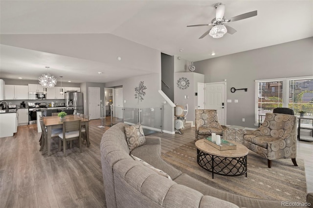 2970 Leoti Dr, Colorado Springs, CO 80922 - living room with ceiling fan, wood finished floors, baseboards, a chandelier, and high vaulted ceiling
