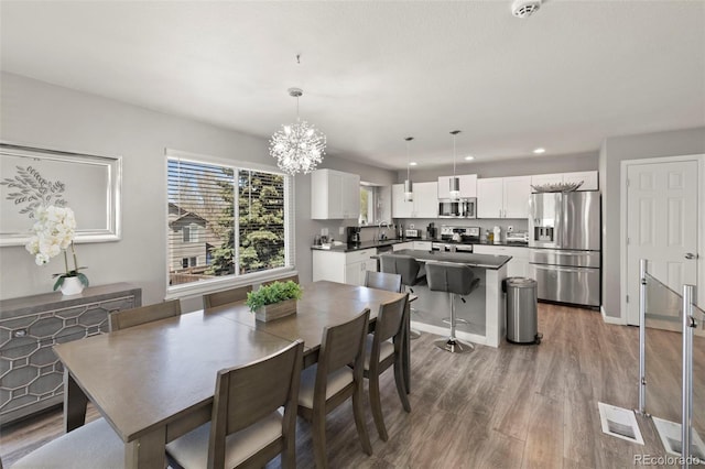 2970 Leoti Dr, Colorado Springs, CO 80922 - dining space with wood finished floors, recessed lighting, and a chandelier