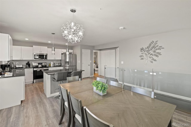 2970 Leoti Dr, Colorado Springs, CO 80922 - dining area with a chandelier, light wood finished floors, and recessed lighting