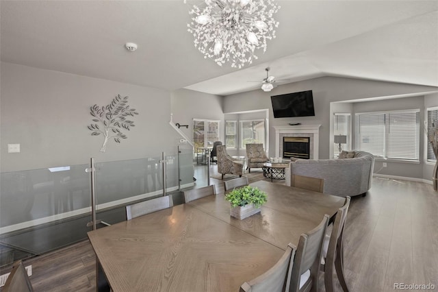 2970 Leoti Dr, Colorado Springs, CO 80922 - dining room featuring a ceiling fan, a glass covered fireplace, baseboards, lofted ceiling, and a chandelier