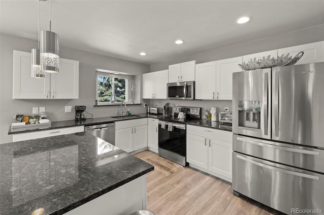 2970 Leoti Dr, Colorado Springs, CO 80922 - kitchen featuring stainless steel appliances, a sink, light wood-style flooring, white cabinetry, and recessed lighting