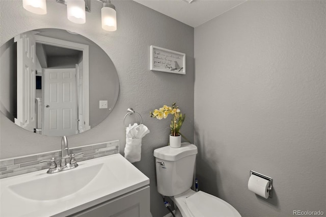 2970 Leoti Dr, Colorado Springs, CO 80922 - half bathroom with toilet, vanity, and tasteful backsplash