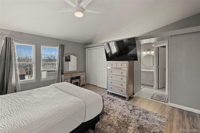2970 Leoti Dr, Colorado Springs, CO 80922 - bedroom with vaulted ceiling, light wood finished floors, baseboards, a ceiling fan, and ensuite bath