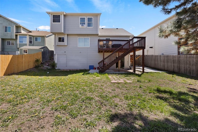2970 Leoti Dr, Colorado Springs, CO 80922 - back of property with stairs, a wooden deck, and a patio area