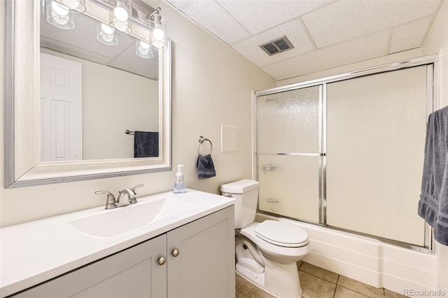 2160 S Vaughn Way Unit 104C, Aurora, CO 80014 - bathroom featuring visible vents, vanity, toilet, a paneled ceiling, and tile patterned floors