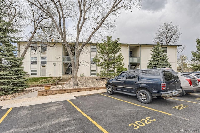 2160 S Vaughn Way Unit 104C, Aurora, CO 80014 - exterior space featuring uncovered parking and stairway
