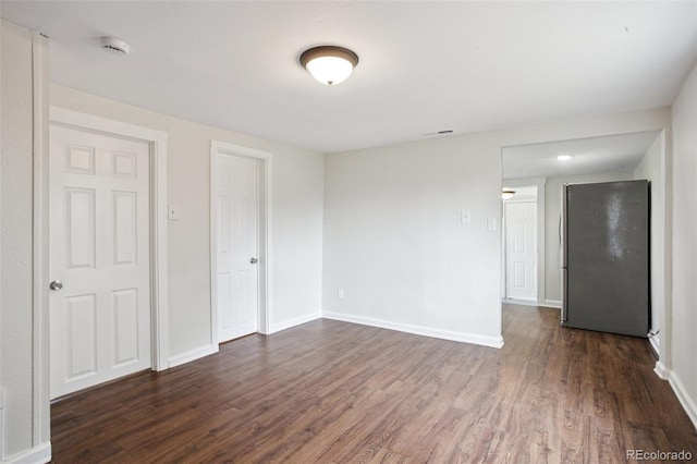 1301 Kenton St, Aurora, CO 80010 - empty room with dark wood-style floors and a smoke detector