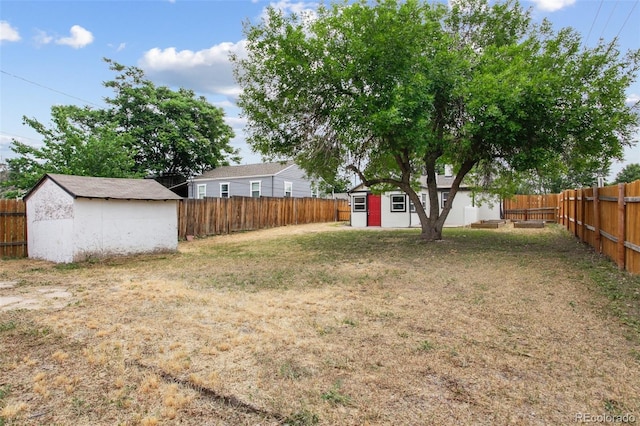 1301 Kenton St, Aurora, CO 80010 - fenced backyard featuring a storage shed