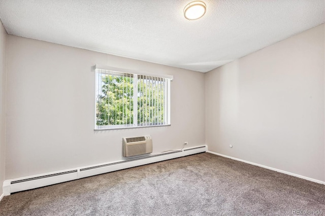 spare room featuring a textured ceiling, carpet flooring, and baseboard heating