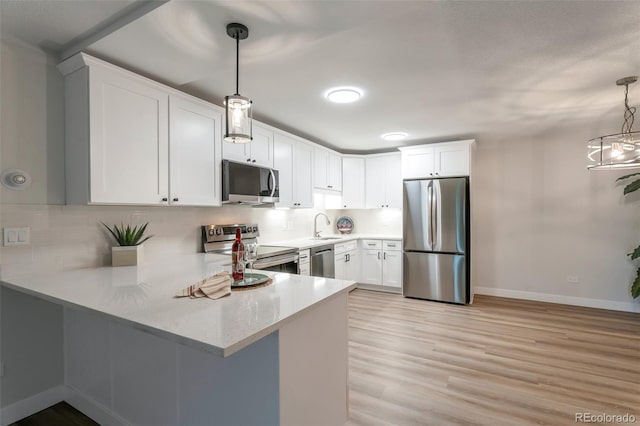 625 S Alton Way Unit 3A, Denver, CO 80247 - kitchen with stainless steel appliances, a peninsula, decorative backsplash, and white cabinets