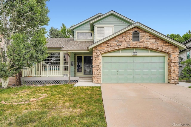 5362 S Danube Ct, Centennial, CO 80015 - view of front of home featuring a front lawn, concrete driveway, stone siding, an attached garage, and a shingled roof