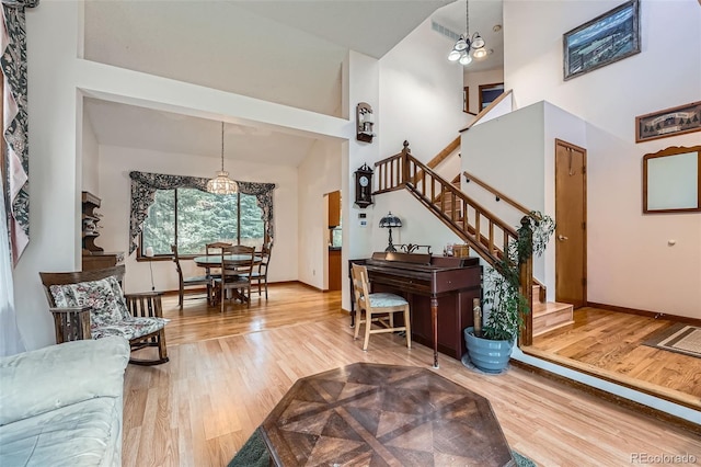 5362 S Danube Ct, Centennial, CO 80015 - living room with high vaulted ceiling, wood finished floors, stairway, and a chandelier