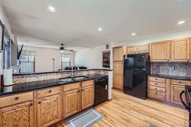 5362 S Danube Ct, Centennial, CO 80015 - kitchen with black appliances, a ceiling fan, light wood-style flooring, dark stone counters, and backsplash
