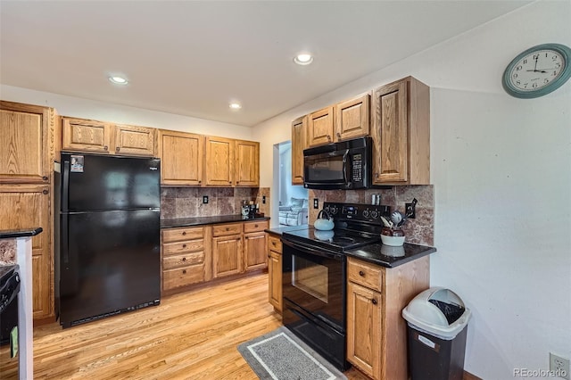 5362 S Danube Ct, Centennial, CO 80015 - kitchen with black appliances, dark countertops, light wood finished floors, backsplash, and recessed lighting