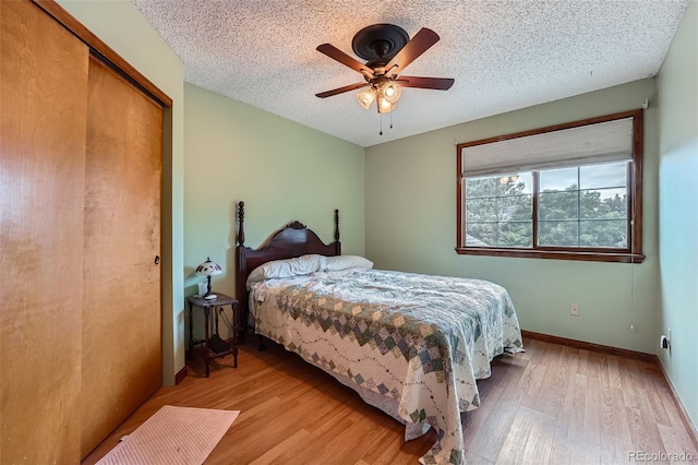 5362 S Danube Ct, Centennial, CO 80015 - bedroom featuring wood finished floors, a textured ceiling, a ceiling fan, and a closet
