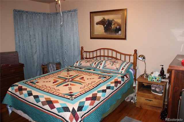 bedroom with dark hardwood / wood-style flooring