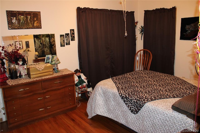 bedroom with dark hardwood / wood-style floors