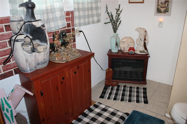 interior space featuring toilet, vanity, and light tile floors