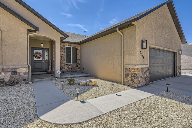 doorway to property with a garage