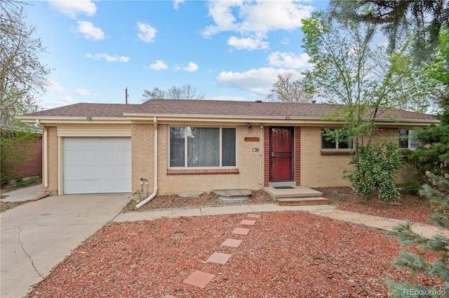 single story home featuring brick siding, driveway, roof with shingles, and a garage