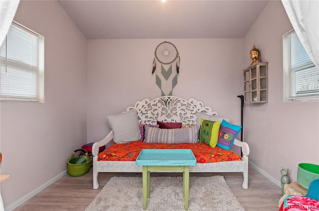 bedroom featuring baseboards and wood finished floors