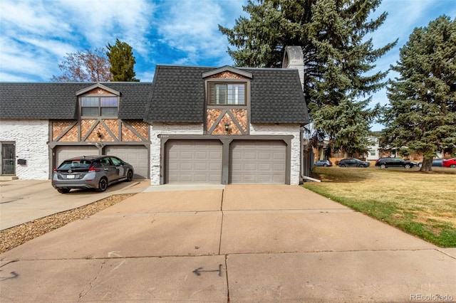 view of front facade with roof with shingles, mansard roof, concrete driveway, a front lawn, and brick siding