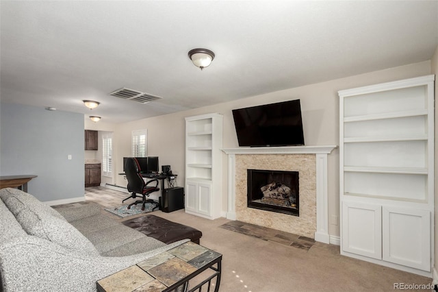 living room with light carpet, visible vents, a fireplace, and baseboards