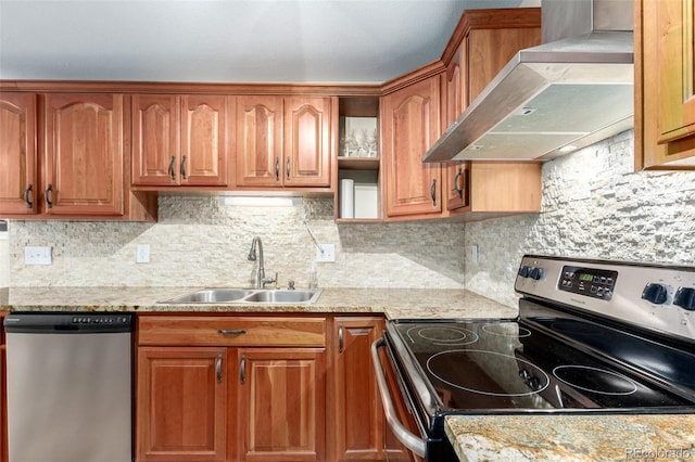 kitchen featuring brown cabinetry, a sink, stainless steel appliances, extractor fan, and tasteful backsplash