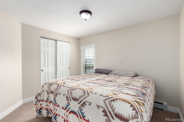 carpeted bedroom featuring a closet, baseboard heating, and baseboards