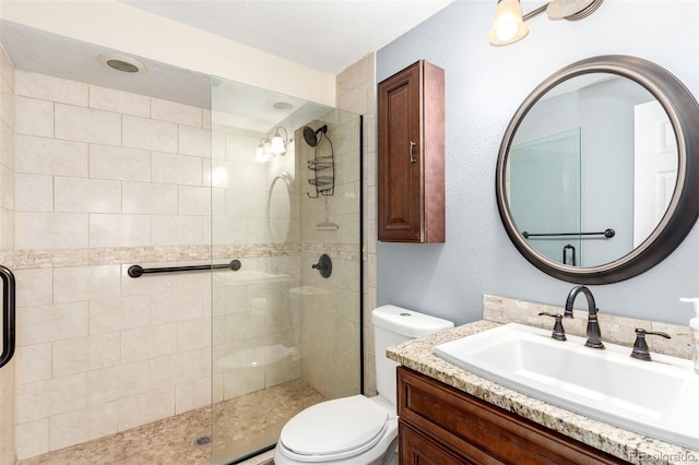 full bath with vanity, toilet, and a shower stall